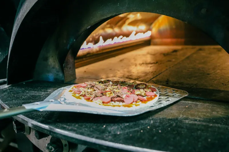 Ascoltare il Fuoco: I Suoni Segreti che Guidano il Pizzaiolo Verso la Pizza Perfetta